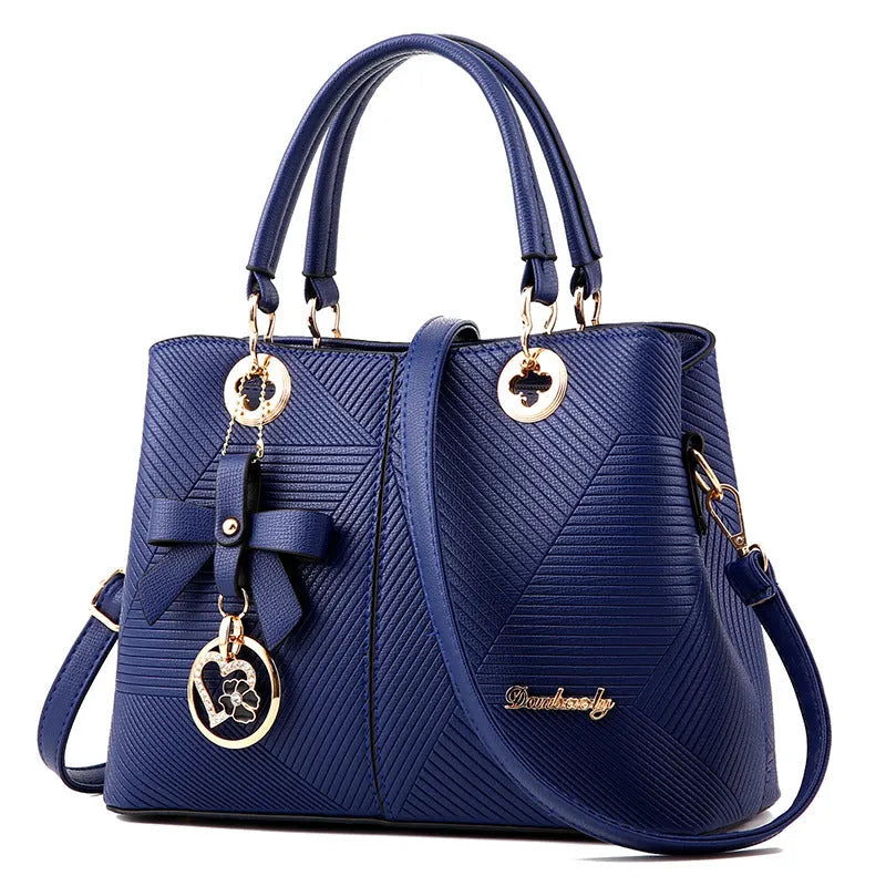 Retro style women's handbag in PU leather with a zipper and adjustable strap in five colour options.
