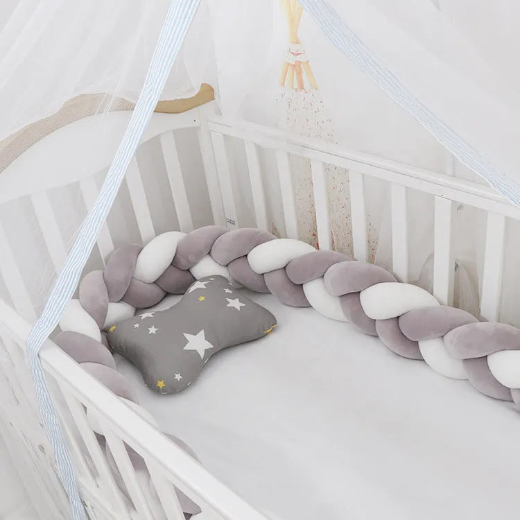 Baby cot bumper braid in spandex crystal velvet, shown in a light grey colour, wrapped around white crib rails.