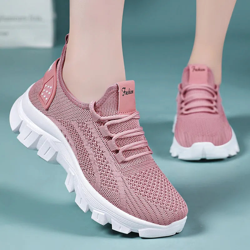 Women's white Flyknit running sneakers with thick PVC sole and lace-up front.