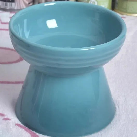 Black ceramic pet bowl with a high foot and neck protector to prevent tipping, shown with flat and slanted rim options.