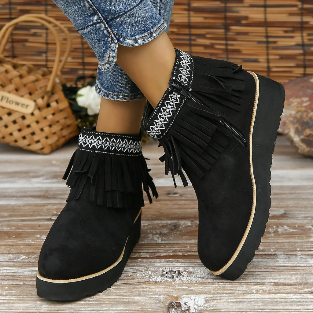 Women's suede wedge ankle boots with side zipper, thick rubber sole, and tassel detailing in dark brown colour