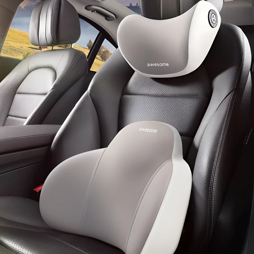 Black and grey memory foam car headrest pillow and lumbar support pillow on a car seat.