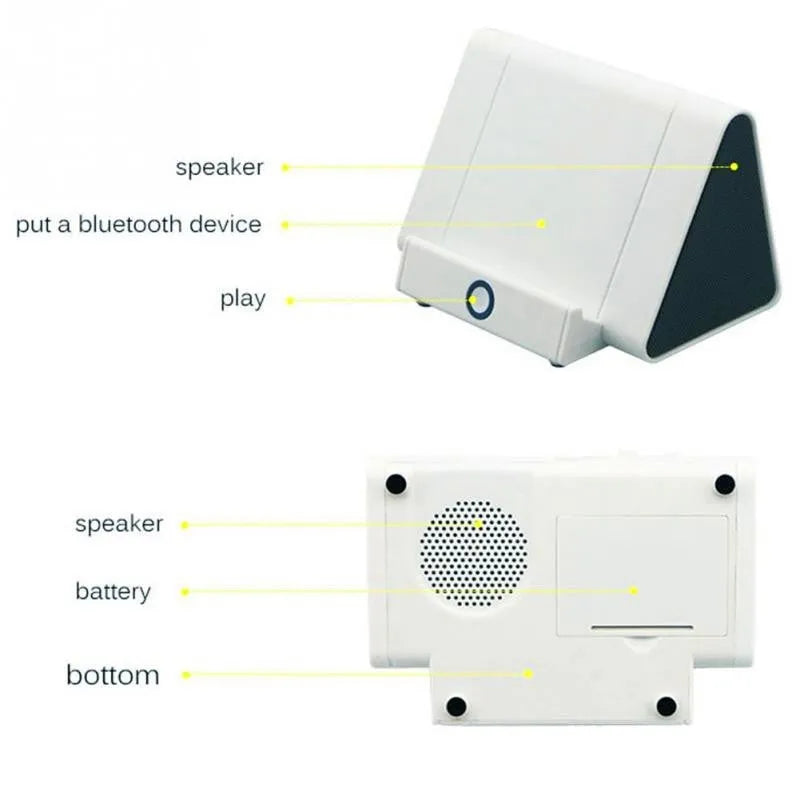Small 5.5 cm round wireless Bluetooth speaker in black or white on a desk next to a mobile phone.