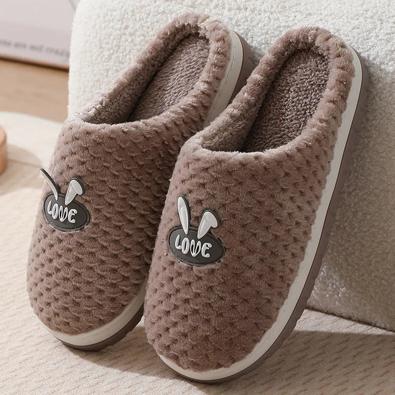 A pair of plush artificial fur house slippers with a baotou toe and a flat rubber sole, shown in a choice of colours.