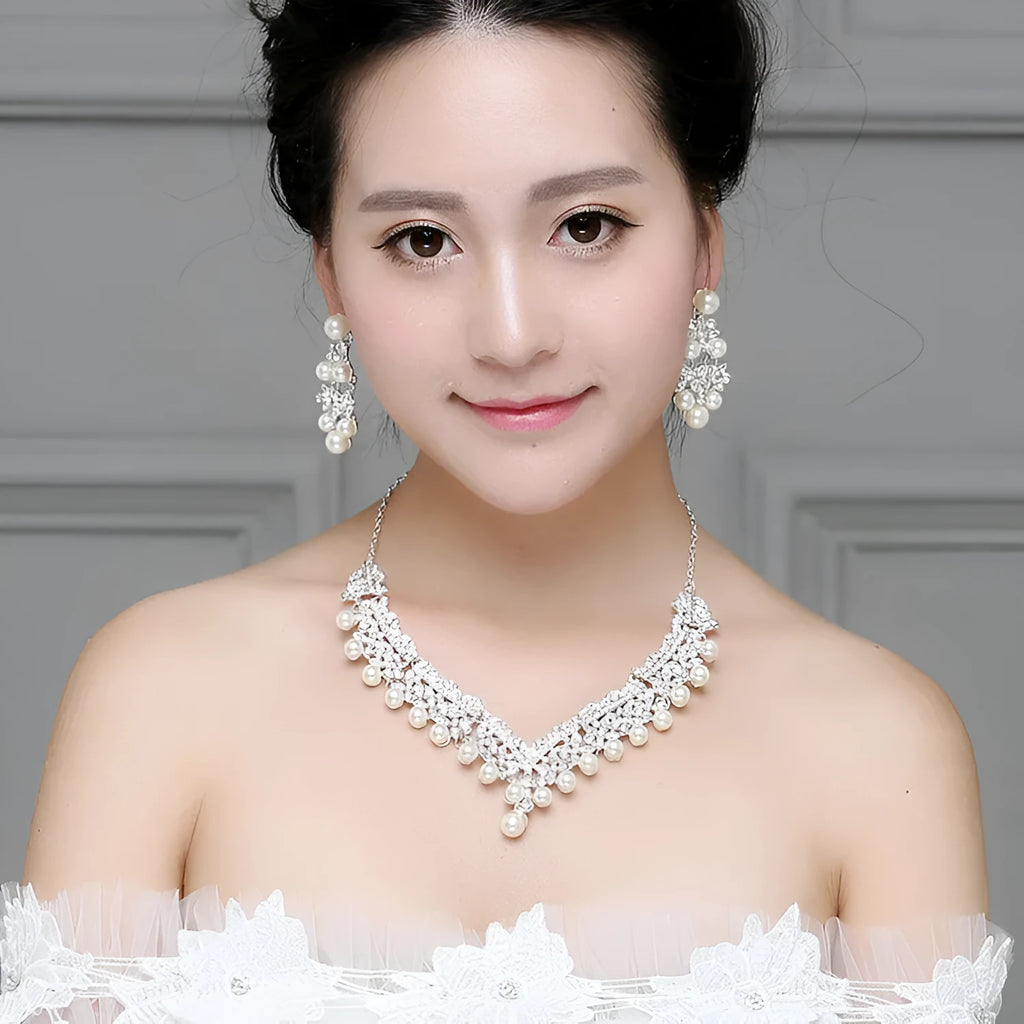 White pearl and crystal bridal set with necklace, earrings, and hair accessory on display