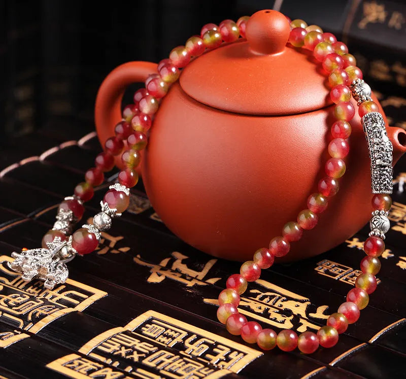 Watermelon crystal bracelet with Chinese knot closure and elephant bead design