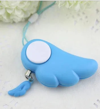 Blue compact personal security alarm clipped to a handbag, 6cm x 3cm, 90dB siren