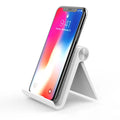 UGREEN Lazy Bracket portable phone holder in black on a desk, holding a mobile phone.