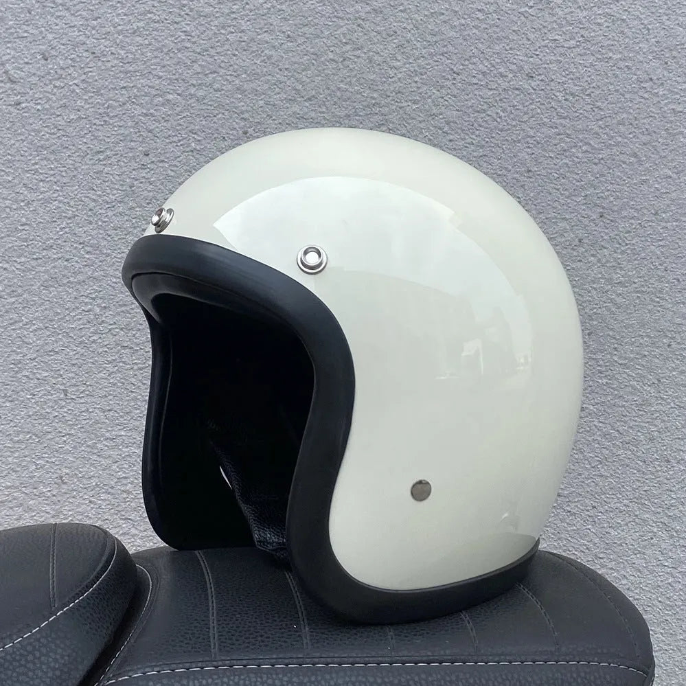 A retro-style grey half helmet for motorcycle riding, shown on a stand.