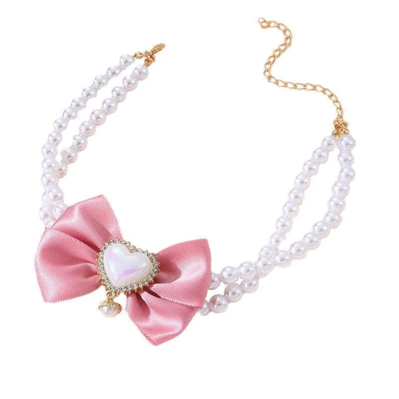 Cute heart shape princess style pet necklace with pearl beads on pink background