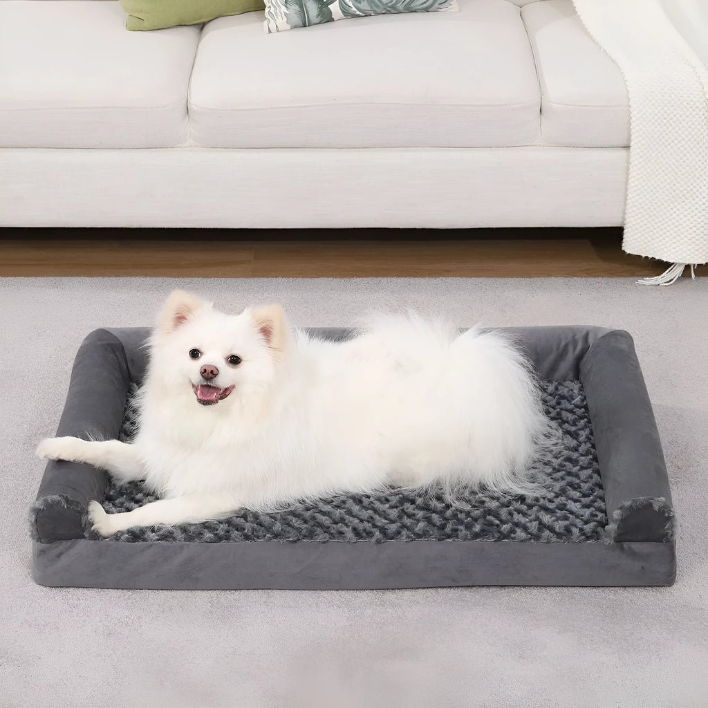 Grey U-shaped removable cover dog sofa bed with embossed velvet fabric, shown in a home setting.