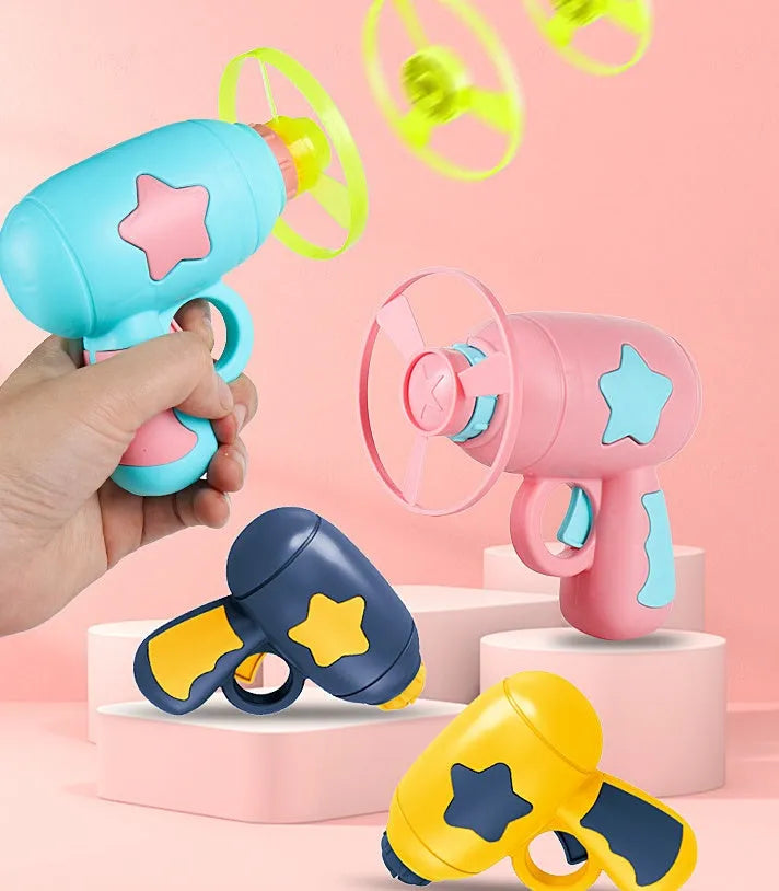 Blue flying saucer launcher gun and three LED flashing discs on a yellow background.