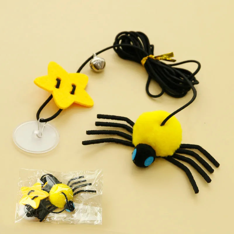 Red and yellow feather cat toy hanging from door on elastic rope with bell spider element for indoor feline play