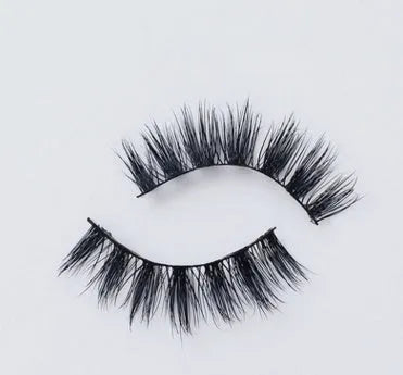 Pair of faux mink eyelashes with long tail and cotton stem against white background