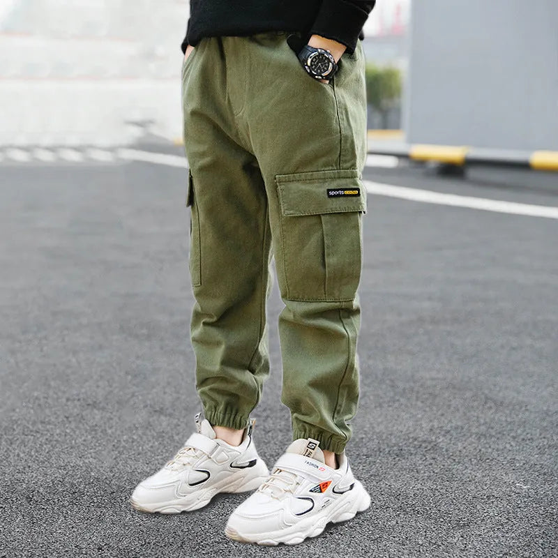 Boys' casual cotton summer trousers in army green, shown flat with size label visible.