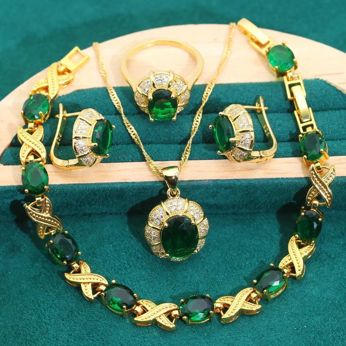 18k gold plated jewellery set showing ring, earrings, bracelet, and necklace with coloured cubic zirconia stones