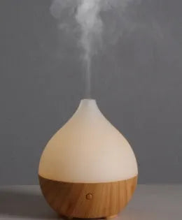 Asakusa wood grain finish vase-shaped aroma diffuser with USB cable on a wooden surface.