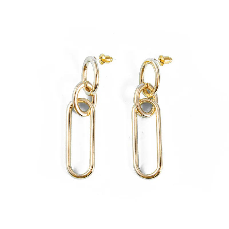 Geometric sterling silver colour hoop earrings with a ring and line design on a white background.