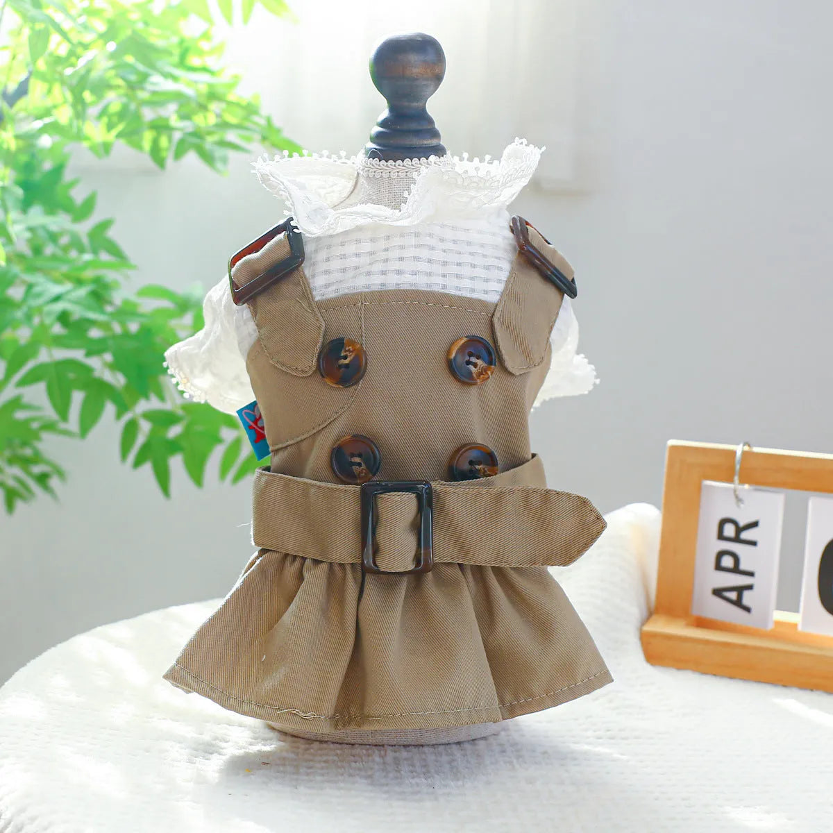Khaki polyester trench coat for dogs on a neutral background showcasing front view and button closure