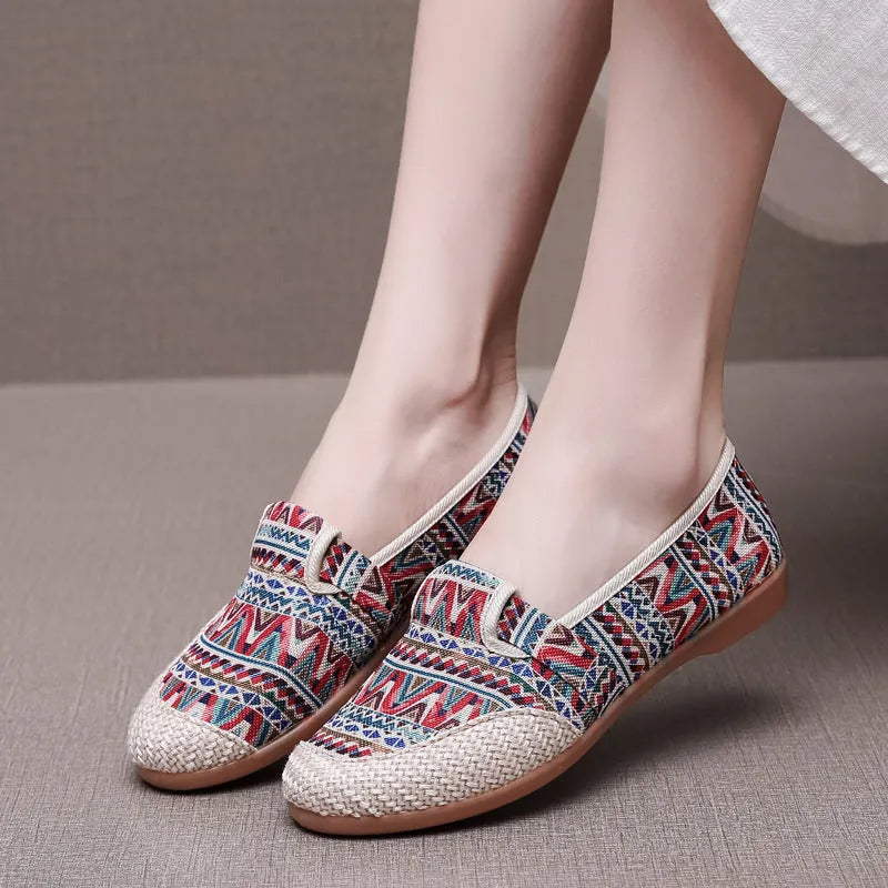 Women's flat heel ethnic cloth shoes in red, green, black, beige, or blue with colour stitching and a shallow mouth.