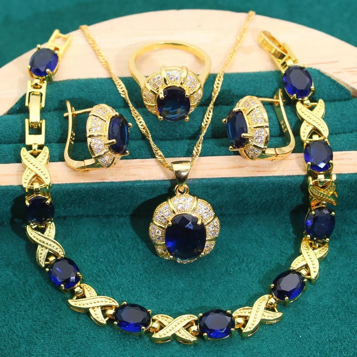 18k gold plated jewellery set showing ring, earrings, bracelet, and necklace with coloured cubic zirconia stones