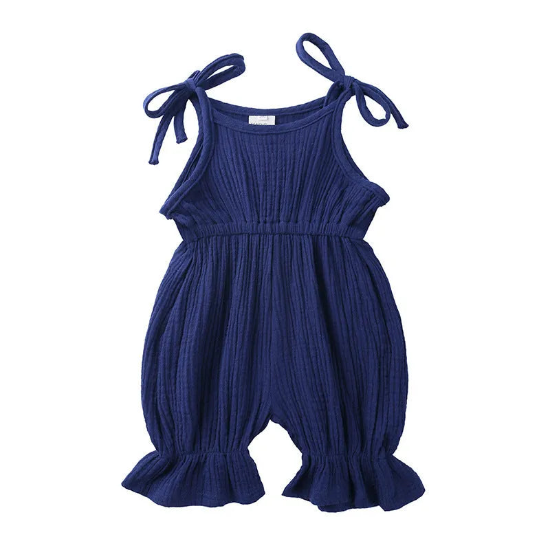Baby girls sleeveless solid cotton romper jumpsuit in pink, front view
