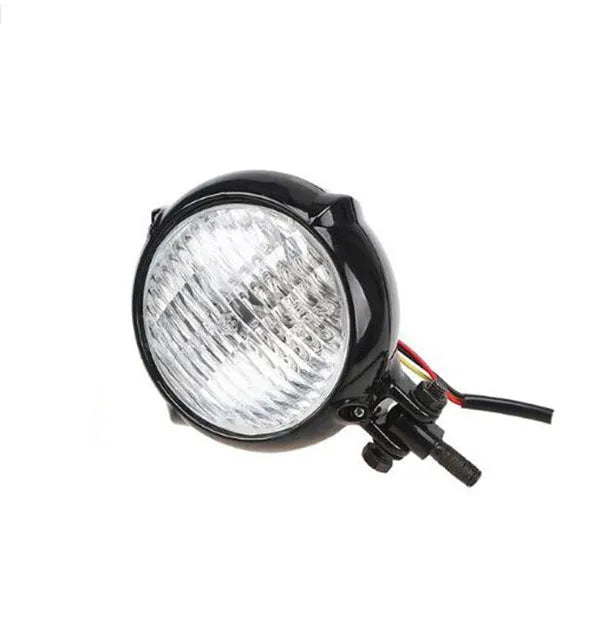 Black electroplated aluminium Harley halogen headlamp with 8cm diameter and yellow glass.
