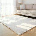 Solid colour plush carpet with soft surface and rectangular shape on hardwood floor