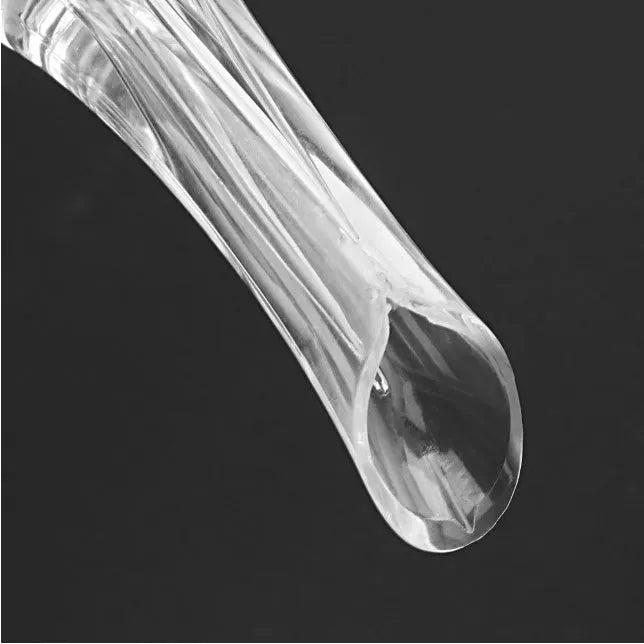 A clear acrylic wine aerator with a stainless steel filter, shown next to a wine glass.