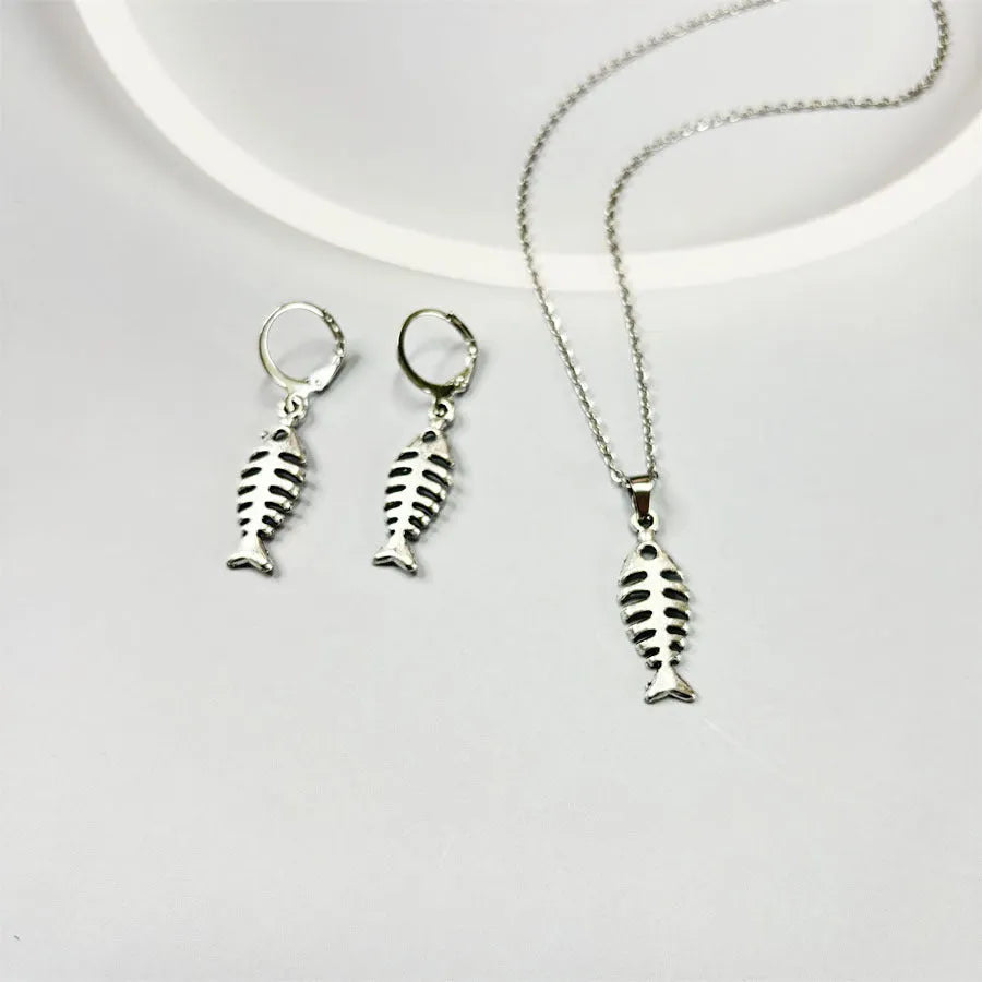 Retro fishbone pendant necklace and earrings set with adjustable alloy chain on a white background