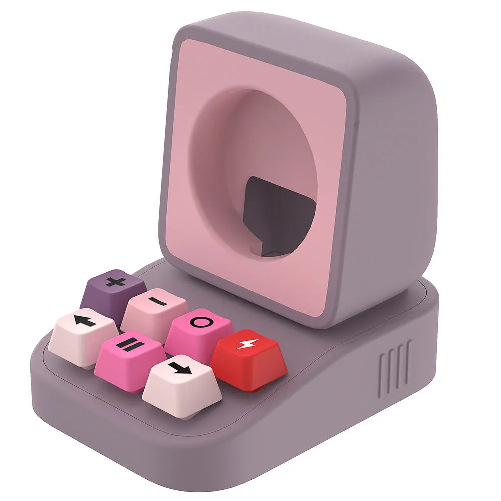 Silicone watch charger bracket in typewriter shape in grey, purple, and yellow colours on a desk