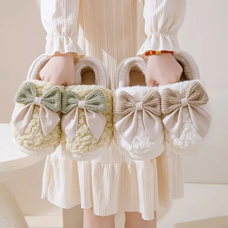 Big bow-knot fluffy slippers with covered heel in pink colour on floor