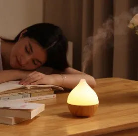 Asakusa wood grain finish vase-shaped aroma diffuser with USB cable on a wooden surface.