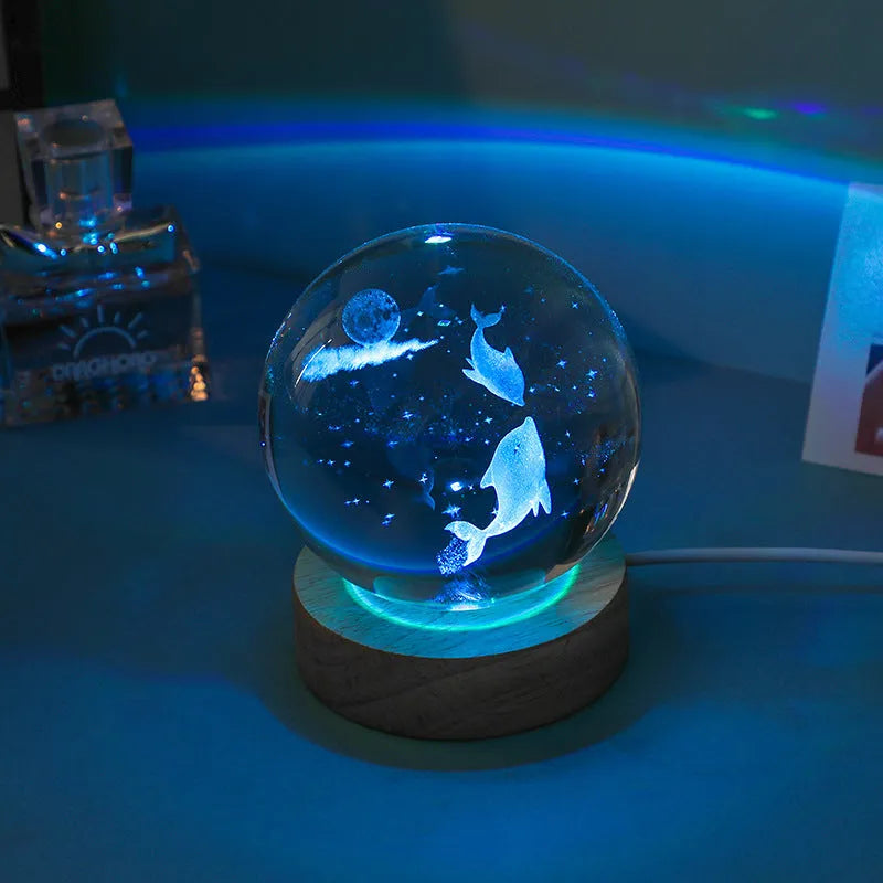 Colorful luminous crystal ball on light wooden base with data cable