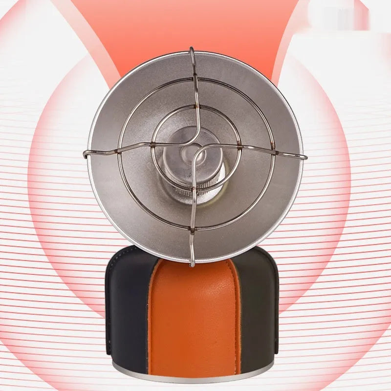 Black and orange portable outdoor heating stove with automatic ignition on a camping table.