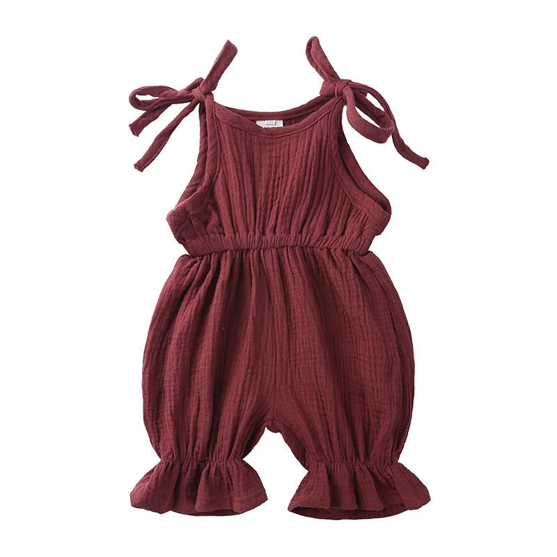 Baby girls sleeveless solid cotton romper jumpsuit in pink, front view