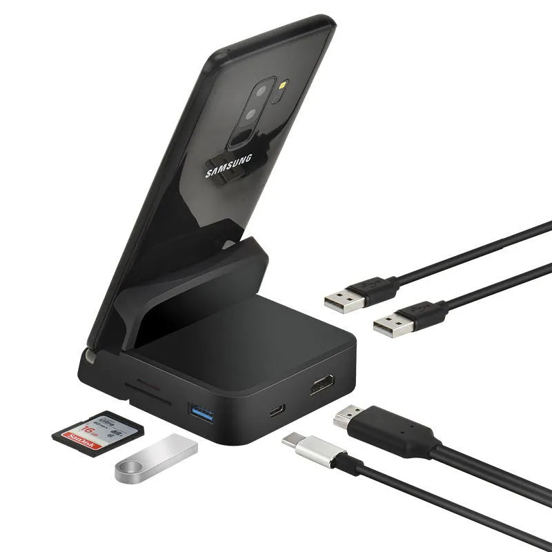 Black USB-C docking station with integrated bracket stand for laptops, featuring USB and HDMI ports, on a desk