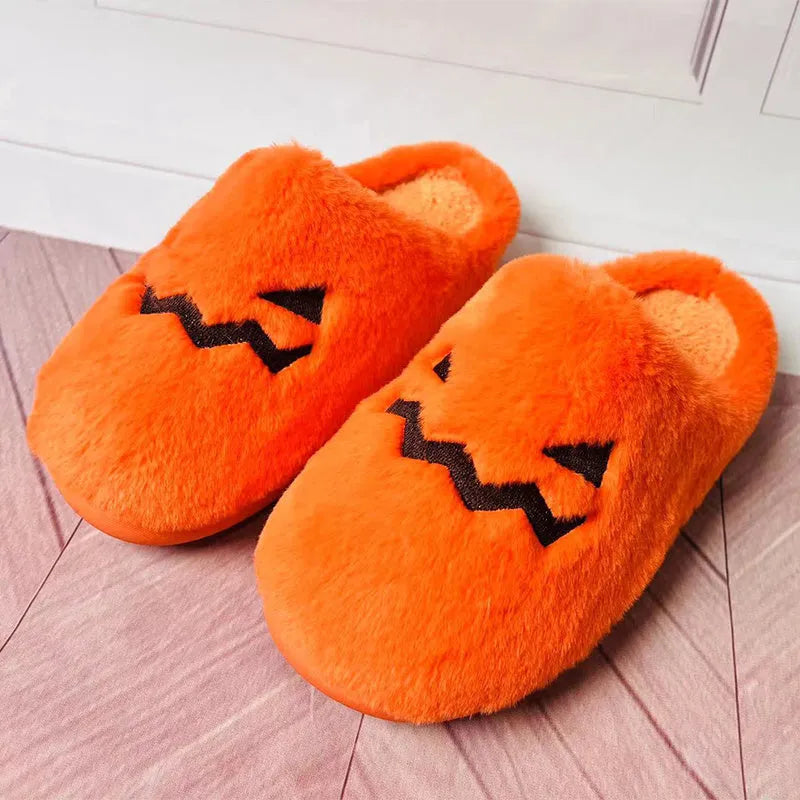 Orange pumpkin-shaped coral velvet plush slippers with a flat PVC sole.
