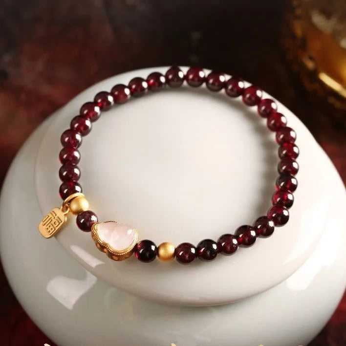 Chinese style gourd bracelet with imitation garnet stones and cultural motifs including Fu character design