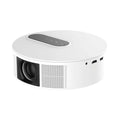 White smart HD home theatre projector with remote control on a wooden table.