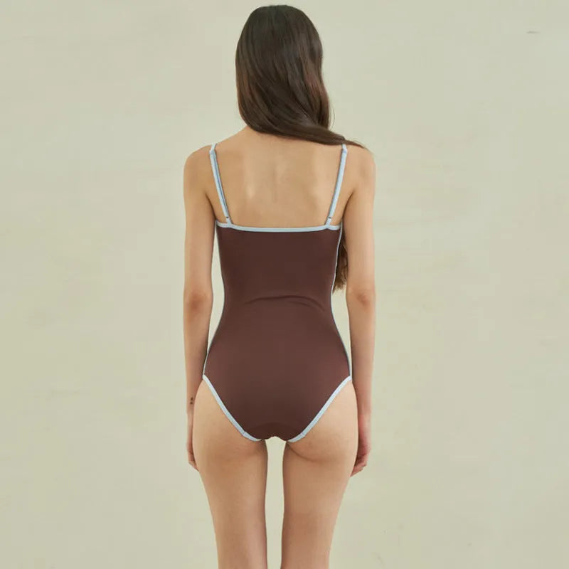Brown triangle one-piece swimsuit for women on a mannequin.