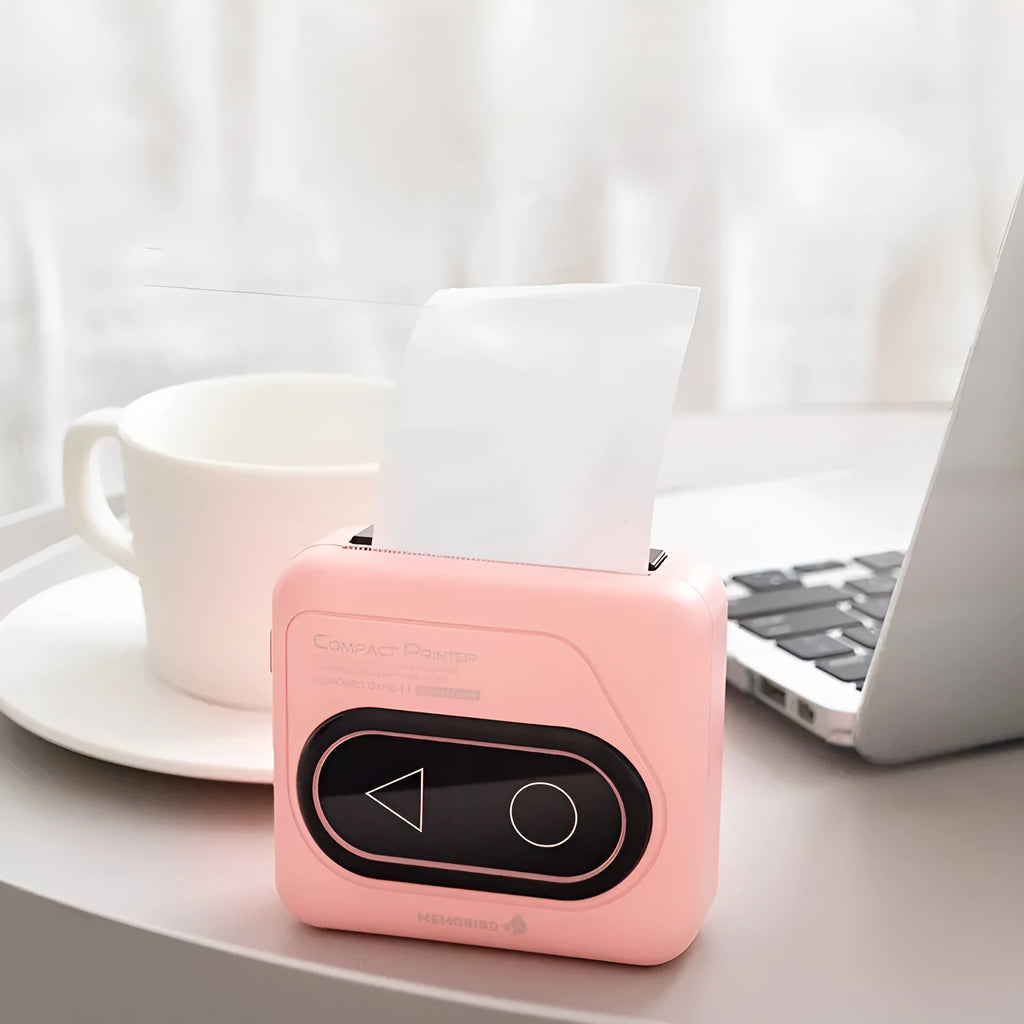 Avocado Green coloured pocket-sized Bluetooth thermal mini printer next to a mobile phone.