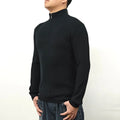 Man wearing a grey half turtleneck zip front sweater, a casual cotton blend pullover.