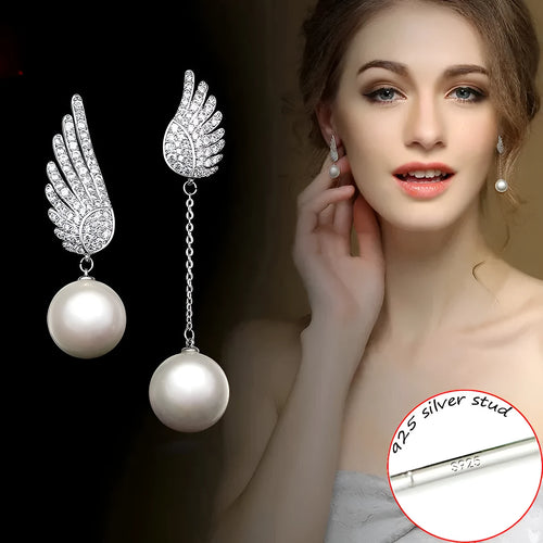 A pair of sterling silver angel wing earrings with diamond cut details and gold-plated gemstone inlay.