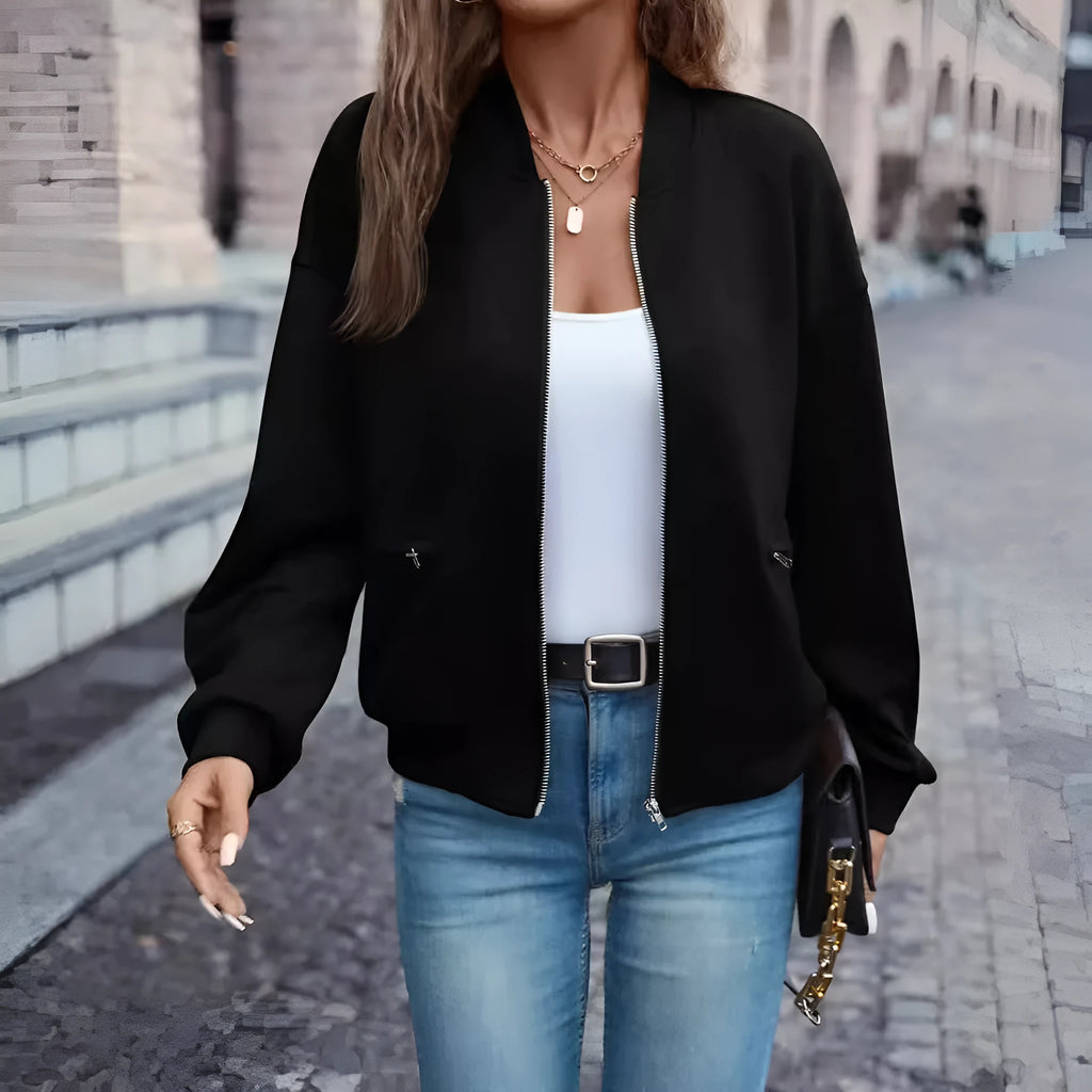 A black women's casual zip-up jacket with long sleeves on a hanger.