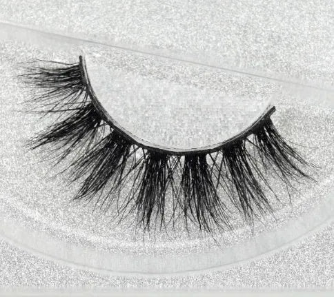 Pair of faux mink eyelashes with long tail and cotton stem against white background