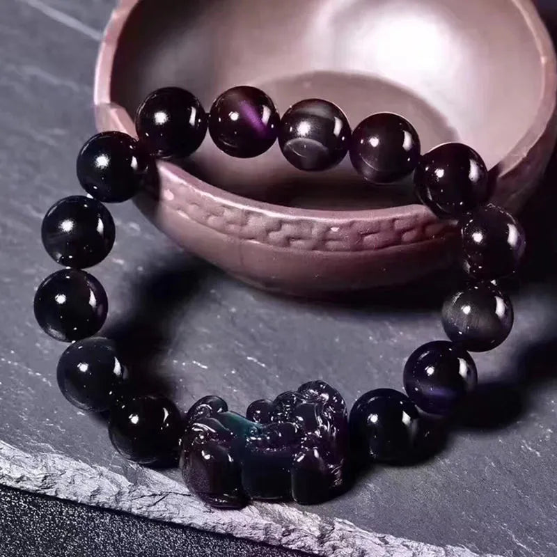 Natural ice colour eye obsidian crystal bracelet with varying bead sizes on wrist