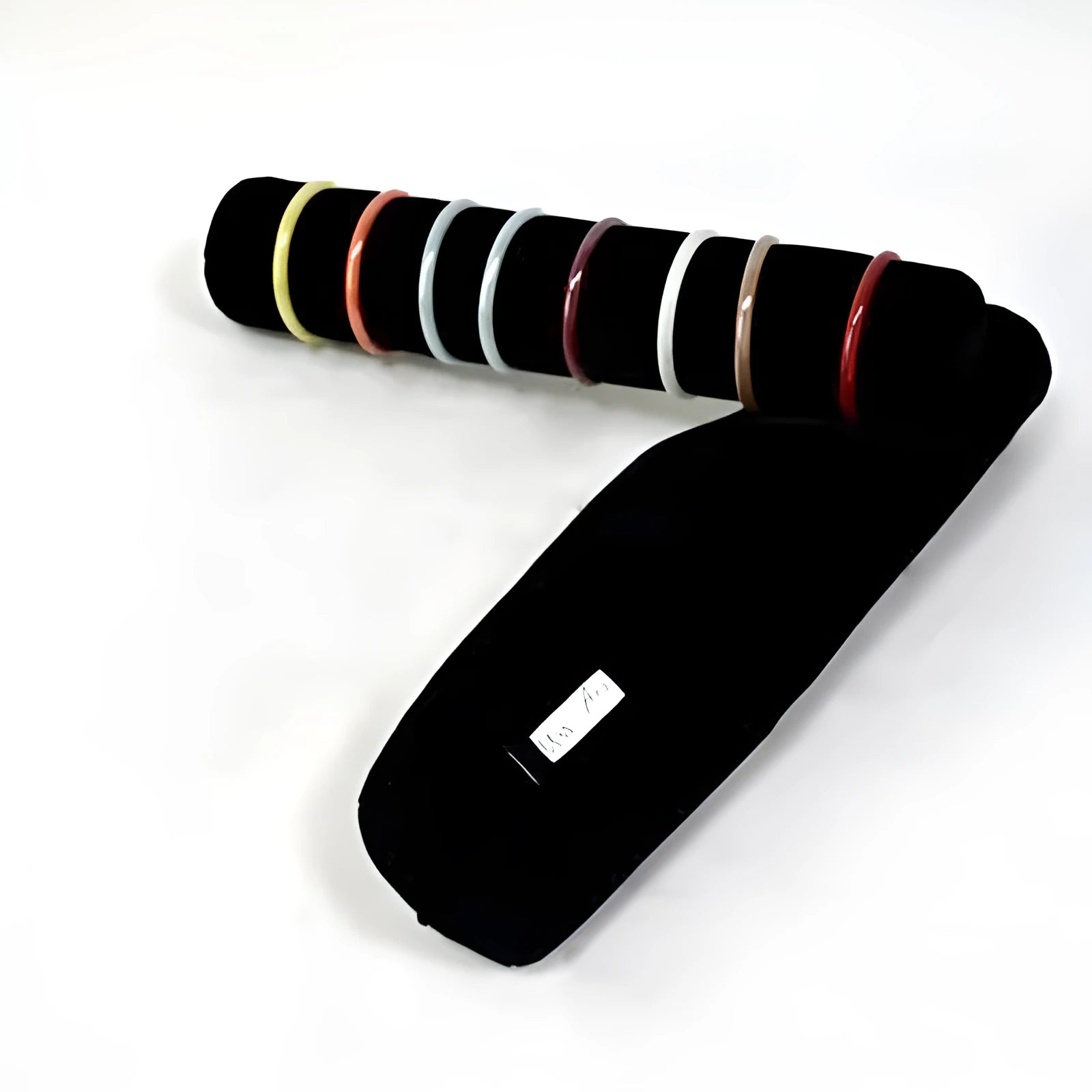 Portable bracelet watch storage bag in black leather with black bracelet stick on a flat surface