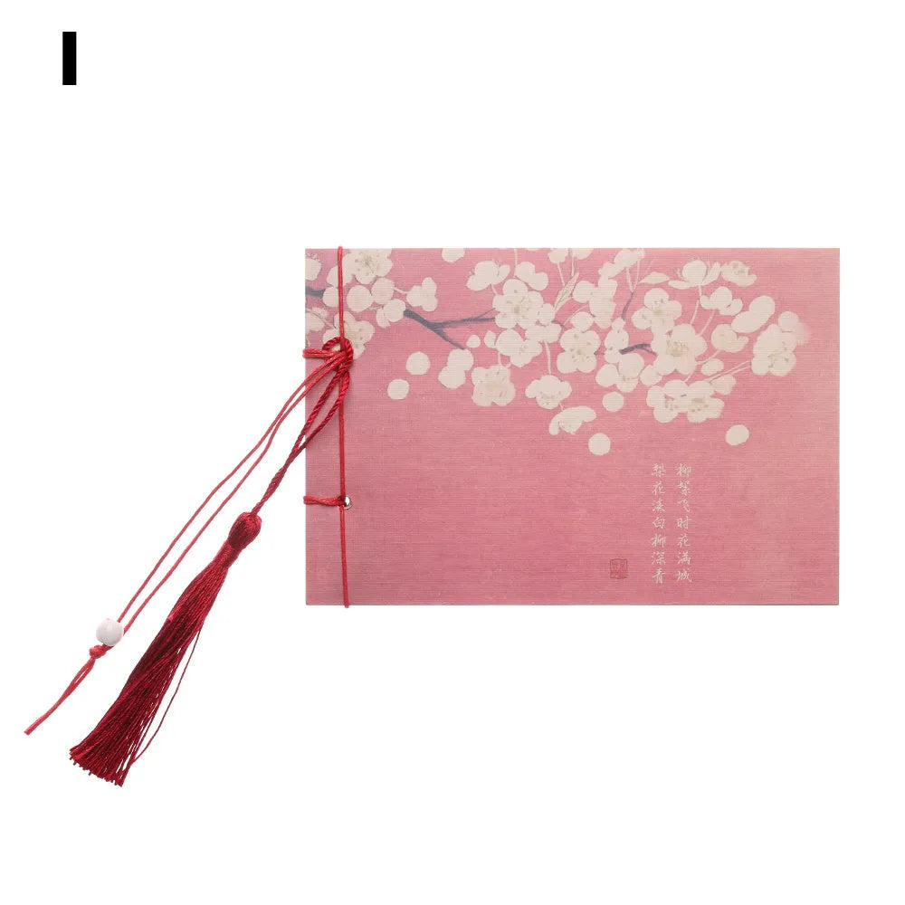 Hand-stitched kraft paper notebook with tassel bookmark on blank pages.
