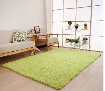 Solid colour plush carpet with soft surface and rectangular shape on hardwood floor